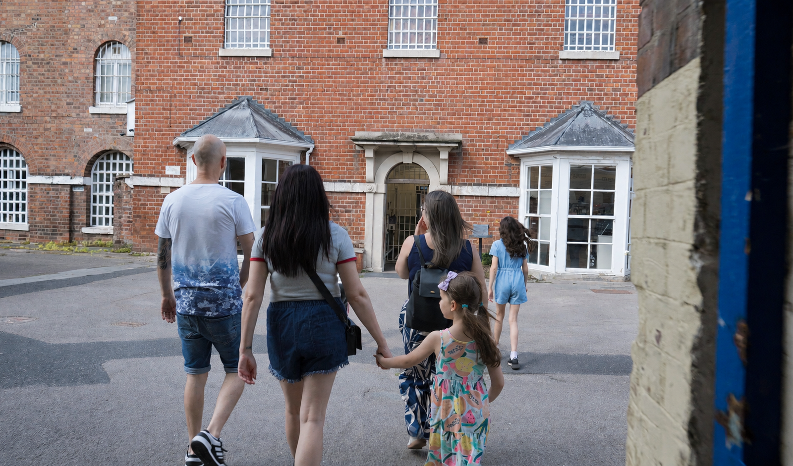 Shrewsbury Prison - Summer Family Offer: Kids Go Free and Eat Free - family and kids entering the prison courtyard