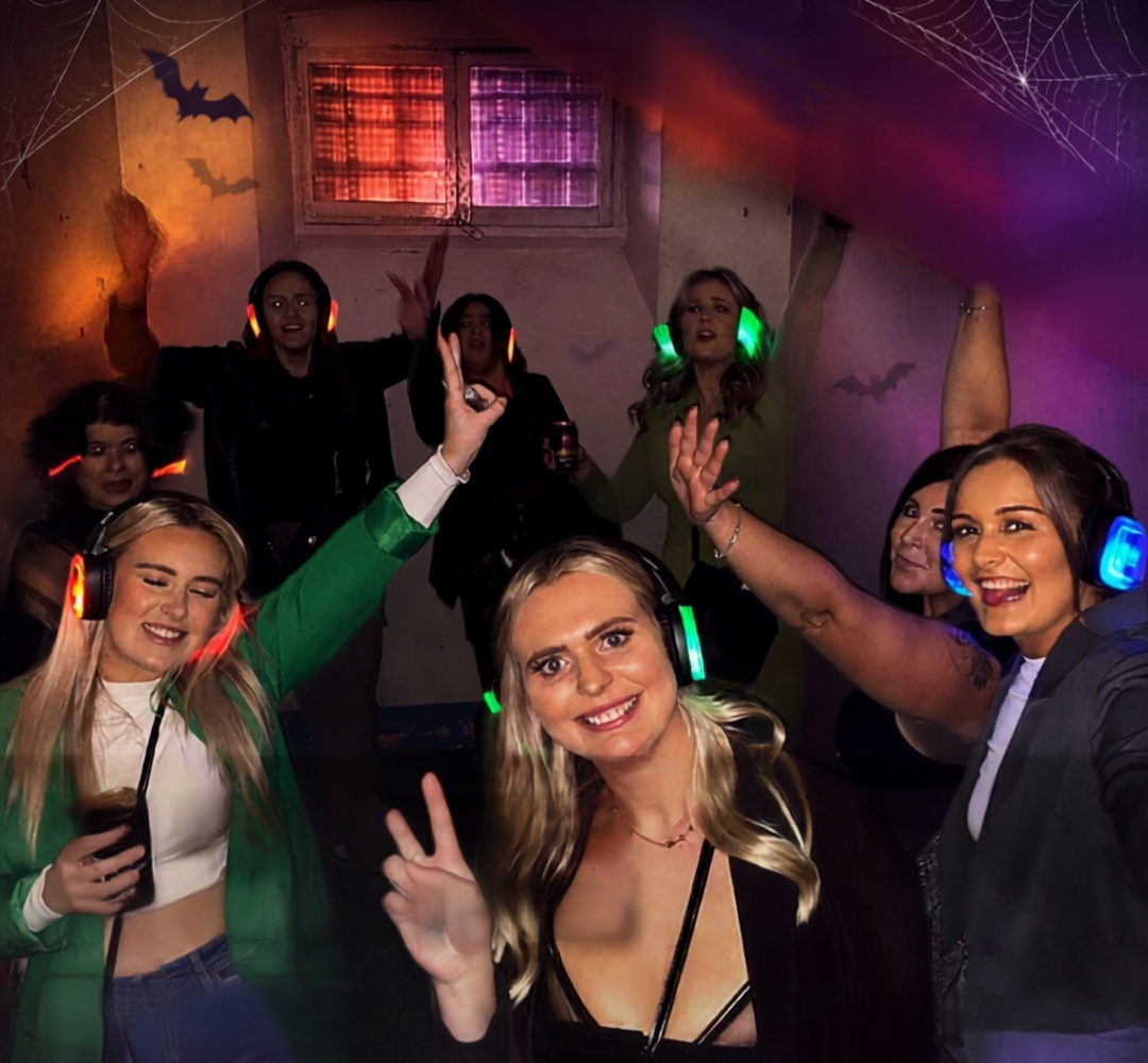 Friends dancing inside a Shrewsbury Prison cell during Halloween Silent Disco party